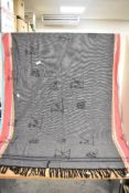 A 20th Century African design tasselled shawl, decorated in multi-coloured stripes on a grey