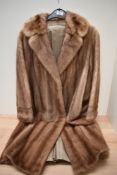 A honey toned vintage mink coat, having pockets to sides.