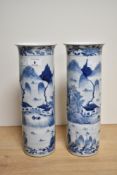 A pair of 19th century Chinese blue and white pottery cylindrical vases, each with slightly flared