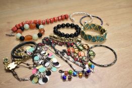An assortment of costume bracelets including beaded examples, cuff bracelets and bangles etc.