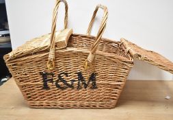 A large vintage wicker Fortmun & Mason picnic basket, no contents.