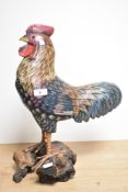 A decorative carved and painted cockerel figure, mounted to a rootwood base 45cm