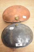 Two late 19th/early 20th century coaching stomach warmers, one being copper, of curved oval form