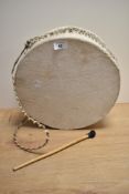 An African / Nigerian animal skinned drum, with drumstick.
