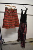 A tartan kilt and a evening gown of black velvet and tartan taffeta.