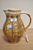 An attractive mid-century Ambleside pottery jug, of baluster form with pinched spout and scrolled