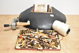 A selection of lace making equipment including lace pillow and selection of lace bobbins, the lace