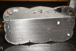 A vintage etched wall mirror having scalloped edges, measuring 69cm x 39cm.
