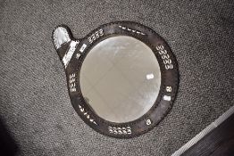 An African leather framed mirror, with shell decoration and beadwork.