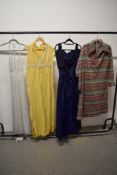 Four mixed vintage dresses, including off the shoulder electric blue dress and yellow maxi dress.