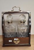 A modern reproduction silver-plate mounted mahogany two bottle tantalus, with lockable fall-front