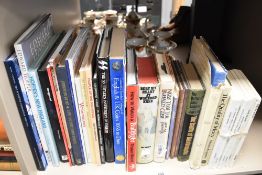 A collection of books, including war, coin and pigeon interest.