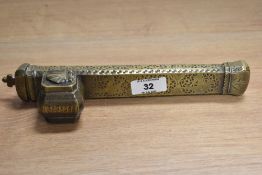 An antique Persian brass scribes case, with lidded ink compartment, decorated throughout with