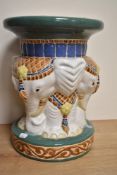 A decorative Chinese style pottery garden seat with elephant head ornamented pedestal, circular seat