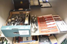 A selection of flatware and cutlery including two sets of boxed steak knifes and forks and a baby'