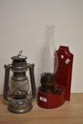 A late 19th/early 20th century red enamelled metal wall mounted oil lamp with Duplex improved