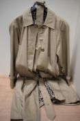 A vintage Ladies Aquascutum rain coat, having belt to waist and fully lined in checked fabric,