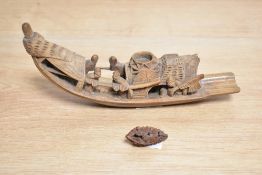 A Chinese carved softwood Sampan river boat, carved with jovial figures and sold along with
