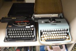 Two cased manual typewriters, one being an Empire and the other a Olivetti Letterer 22.