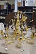 A modern eight branch light fitting, having glass drops. Thought to be gold plated