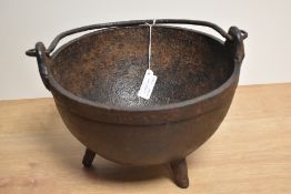 An appealing 19th century cast-iron cauldron, of traditional dished circular form with three short