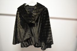 A 1930s black cape, having large collar and large self covered buttons.