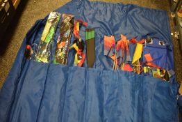 Sixteen large kites in a homemade kite bag.