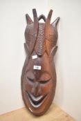 A large African carved hardwood tribal mask, measuring 66cm tall