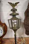 An early 20th century converted carriage lamp having eagle cermount.