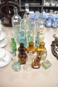 A collection of vintage glass bottles including medicine, oil and water bottles etc.