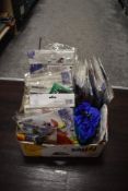 A carton of kites and spinners, most being new and in original packaging.