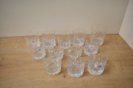 Eleven cut glass low ball glasses, having solid bases sold along with a similar but larger whiskey