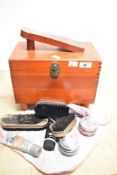 A vintage stained wood shoe cleaning box of dovetailed construction containing shoe shining
