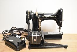 A Singer Manufacturing Company model 222K sewing machine with Singer sewing motor controller (foot