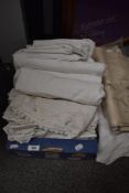 A collection of vintage and antique bed linen, table linen and huckaback hand towels.