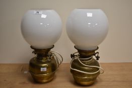 A pair of Victorian brass table oil lamps with glass shades, converted to electricity and