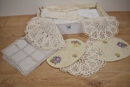 A small selection of crotched and hand embroidered table doilies.