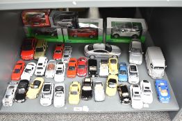 A shelf of Welly mixed scale Die-casts including BMW, Jaguar, Mercedes etc, 1:24 and smaller, 37