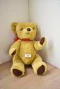 A Deans Childs Play Toys yellow plush Teddy Bear having plastic eyes and nose, stitched mouth and
