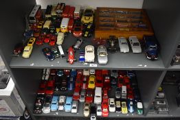 Two shelves of modern playworn diecasts including Corgi, Solido, Kinsmart, Days Gone etc, along with