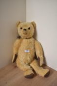 A mid 20th century straw filled Golden Teddy Bear having plastic eyes replacement stitched nose