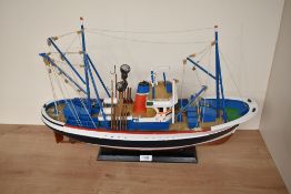A wooden model Fishing Boat, on fitted stand, length 60cm