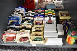 A shelf of Lledo and similar Die-casts, all in window boxes and plastic/card packets, 62 in total