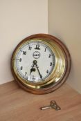 A Story, Barrow brass bulkhead clock with enamelled and numbered, spade hands and seconds dial,