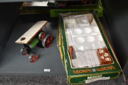 A Mamod Live Steam TE1 Steam Tractor with a Mamod Traction Engine Kit box