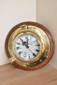 A Rickmer Rickmers Quartz Ships Time brass Porthole Ships clock with roman numeral and 13-00 dial,