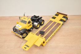 An unnamed Die-cast scale model, Case Equipment Sales And Service Wide Load Wagon and Trailer,