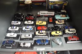 A shelf of modern Die-casts all on display stands including Aston Martin DB5, Ferrari 275 GTB,
