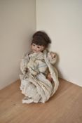 A German Heubach Koppelsdorf Bisque Headed Doll having fixed open painted blue eyes, open mouth with