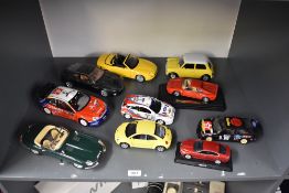 Ten Burago mixed scale Die-casts including Jaguar E Type, Citroen WRO, Aston Martin Vanquish,